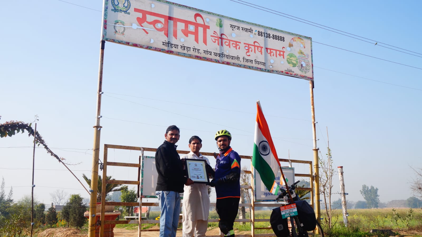 Swami Natural Farming entrance with visitors and Indian flag