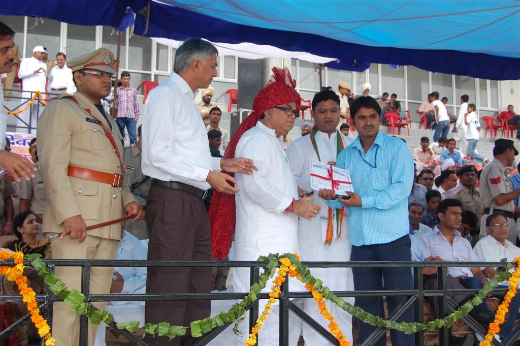Bhanwar Lal Swami receiving recognition on a public stage